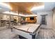 Spacious game room with a pool table, seating areas, and a mounted television at 450 Knights Run Ave # 1003, Tampa, FL 33602