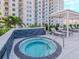 Rooftop hot tub with lounge chairs and community building in the background at 450 Knights Run Ave # 1003, Tampa, FL 33602