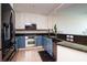 Modern kitchen with stainless steel appliances, granite countertops, and custom cabinetry at 450 Knights Run Ave # 1003, Tampa, FL 33602