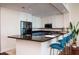Bright kitchen with a breakfast bar featuring granite countertops, modern appliances, and barstool seating at 450 Knights Run Ave # 1003, Tampa, FL 33602