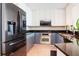 Modern kitchen featuring stainless steel appliances, granite countertops, and stylish two-tone cabinetry at 450 Knights Run Ave # 1003, Tampa, FL 33602