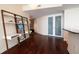 Open-concept living space featuring hardwood floors, a decorative shelving unit, and frosted glass doors at 450 Knights Run Ave # 1003, Tampa, FL 33602