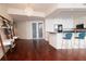 Spacious living room with hardwood floors, stylish shelving, and an open layout into the modern kitchen at 450 Knights Run Ave # 1003, Tampa, FL 33602