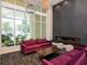 Bright lobby with floor-to-ceiling windows, modern furniture, and an elegant fireplace at 450 Knights Run Ave # 1003, Tampa, FL 33602