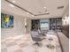 Inviting lounge space featuring stylish seating, built-in shelving, and a modern television at 450 Knights Run Ave # 1003, Tampa, FL 33602