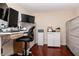 Bright office space with modern desk setup, storage cabinets, and hardwood floors, creating a productive atmosphere at 450 Knights Run Ave # 1003, Tampa, FL 33602