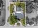 Aerial view of the property featuring a screened-in pool, lush landscaping, and a well-maintained home at 454 35Th Ne Ave, St Petersburg, FL 33704