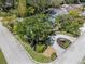 Aerial view of landscaped yard, circular driveway, and mature trees at 454 35Th Ne Ave, St Petersburg, FL 33704