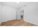 Bright bedroom with hardwood floors, closet space, and open door to a kitchen at 454 35Th Ne Ave, St Petersburg, FL 33704