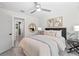 Bright bedroom featuring a ceiling fan, neutral decor, and access to an ensuite bathroom for added convenience at 454 35Th Ne Ave, St Petersburg, FL 33704