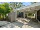 Exterior view of the covered parking area, featuring a well-maintained structure and mature trees at 454 35Th Ne Ave, St Petersburg, FL 33704