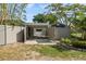 Exterior view of the covered parking area, surrounded by lush landscaping and privacy fencing at 454 35Th Ne Ave, St Petersburg, FL 33704