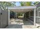 Exterior view of the covered parking area, showcasing its functional design and surrounding landscape at 454 35Th Ne Ave, St Petersburg, FL 33704
