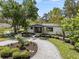 Charming home featuring a circular driveway, meticulous landscaping, and a welcoming entrance at 454 35Th Ne Ave, St Petersburg, FL 33704