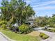 Beautiful front yard with lush landscaping, mature trees, and circular driveway at 454 35Th Ne Ave, St Petersburg, FL 33704