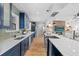 Modern kitchen featuring navy cabinets, a large island, and stainless-steel appliances at 454 35Th Ne Ave, St Petersburg, FL 33704