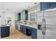 Modern kitchen with stylish blue cabinets, stainless steel appliances, and subway tile backsplash at 454 35Th Ne Ave, St Petersburg, FL 33704