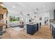 Open concept kitchen and living room featuring hardwood floors, blue island and stainless steel appliances at 454 35Th Ne Ave, St Petersburg, FL 33704