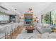 Cozy living area next to a modern kitchen, with a decorative fireplace feature and ample seating at 454 35Th Ne Ave, St Petersburg, FL 33704