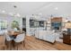 Bright, open-concept living and dining area with hardwood floors, modern lighting, and neutral decor at 454 35Th Ne Ave, St Petersburg, FL 33704