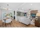 Open-concept living space with hardwood floors and modern finishes connecting kitchen, dining, and living areas at 454 35Th Ne Ave, St Petersburg, FL 33704