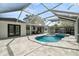 Expansive screened-in pool with a spa, covered seating area, and outdoor kitchen, ideal for year-round enjoyment at 454 35Th Ne Ave, St Petersburg, FL 33704
