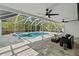 Inviting screened-in pool with a spa, ample seating, and lush landscaping, perfect for outdoor relaxation and entertainment at 454 35Th Ne Ave, St Petersburg, FL 33704