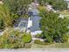 Aerial view of screened-in pool and beautifully landscaped yard with mature trees at 454 35Th Ne Ave, St Petersburg, FL 33704