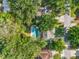 Aerial view of a private backyard oasis with a pool and patio surrounded by mature trees at 4616 S Matanzas Ave, Tampa, FL 33611