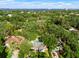 Aerial view of a home surrounded by mature trees with a pool, and the ocean visible in the distance at 4616 S Matanzas Ave, Tampa, FL 33611