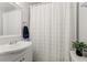 Bright bathroom with a white vanity and a shower featuring a decorative white shower curtain at 4616 S Matanzas Ave, Tampa, FL 33611
