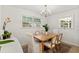 Bright dining room featuring a wooden table, four chairs, and a window for natural light at 4616 S Matanzas Ave, Tampa, FL 33611