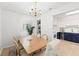 Bright dining room featuring a wooden table, six chairs, and a view into the white and navy kitchen at 4616 S Matanzas Ave, Tampa, FL 33611