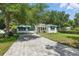 Charming home features a brick driveway, lush lawn, mature landscaping, and lovely curb appeal at 4616 S Matanzas Ave, Tampa, FL 33611