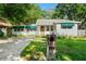 Exterior view of home with a brick mailbox and green awnings, showcasing its charming street presence at 4616 S Matanzas Ave, Tampa, FL 33611