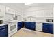 Charming kitchen with white and blue cabinets, modern appliances, and a built-in wine cooler at 4616 S Matanzas Ave, Tampa, FL 33611