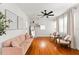 Spacious living room with hardwood floors, pink sofa, stylish decor, and natural light at 4616 S Matanzas Ave, Tampa, FL 33611