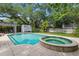 Inviting pool and attached hot tub in backyard at 4616 S Matanzas Ave, Tampa, FL 33611