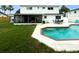 Expansive backyard featuring a sparkling pool and well-maintained lawn ideal for outdoor activities at 4725 Soapstone Dr, Tampa, FL 33615