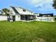 Lush green backyard featuring an in-ground pool and a screened-in porch area, great for outdoor living at 4725 Soapstone Dr, Tampa, FL 33615