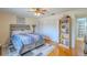 A bedroom displays a ceiling fan, hardwood floors, a bed, shelving and two large closets at 4725 Soapstone Dr, Tampa, FL 33615