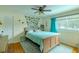 Charming bedroom featuring hardwood floors, ceiling fan, and colorful accents at 4725 Soapstone Dr, Tampa, FL 33615