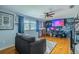 Cozy bonus room with hardwood floors, ample lighting and a gaming setup at 4725 Soapstone Dr, Tampa, FL 33615