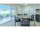 The dining room is surrounded by sliding glass doors and provides views to the outdoors at 4725 Soapstone Dr, Tampa, FL 33615