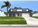 Charming two-story home with a well-manicured lawn, brick facade, and a convenient two-car garage at 4725 Soapstone Dr, Tampa, FL 33615