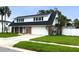 Charming two-story home featuring a well-maintained lawn, a brick facade, and a two-car garage at 4725 Soapstone Dr, Tampa, FL 33615