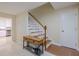 Bright foyer features tile flooring, a staircase with wooden handrail, and a charming entry bench at 4725 Soapstone Dr, Tampa, FL 33615