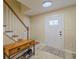 Bright foyer features tile flooring, a decorative front door, and a staircase leading to the upper level at 4725 Soapstone Dr, Tampa, FL 33615