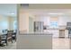 Modern kitchen with stainless steel appliances, white cabinetry, and an open layout to the dining area at 4725 Soapstone Dr, Tampa, FL 33615