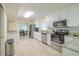 Modern kitchen featuring stainless steel appliances, white cabinets, and stone countertops at 4725 Soapstone Dr, Tampa, FL 33615